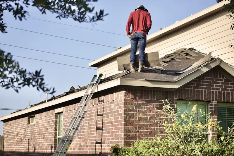 Professional roofer working on a residential roof in Spring Mills